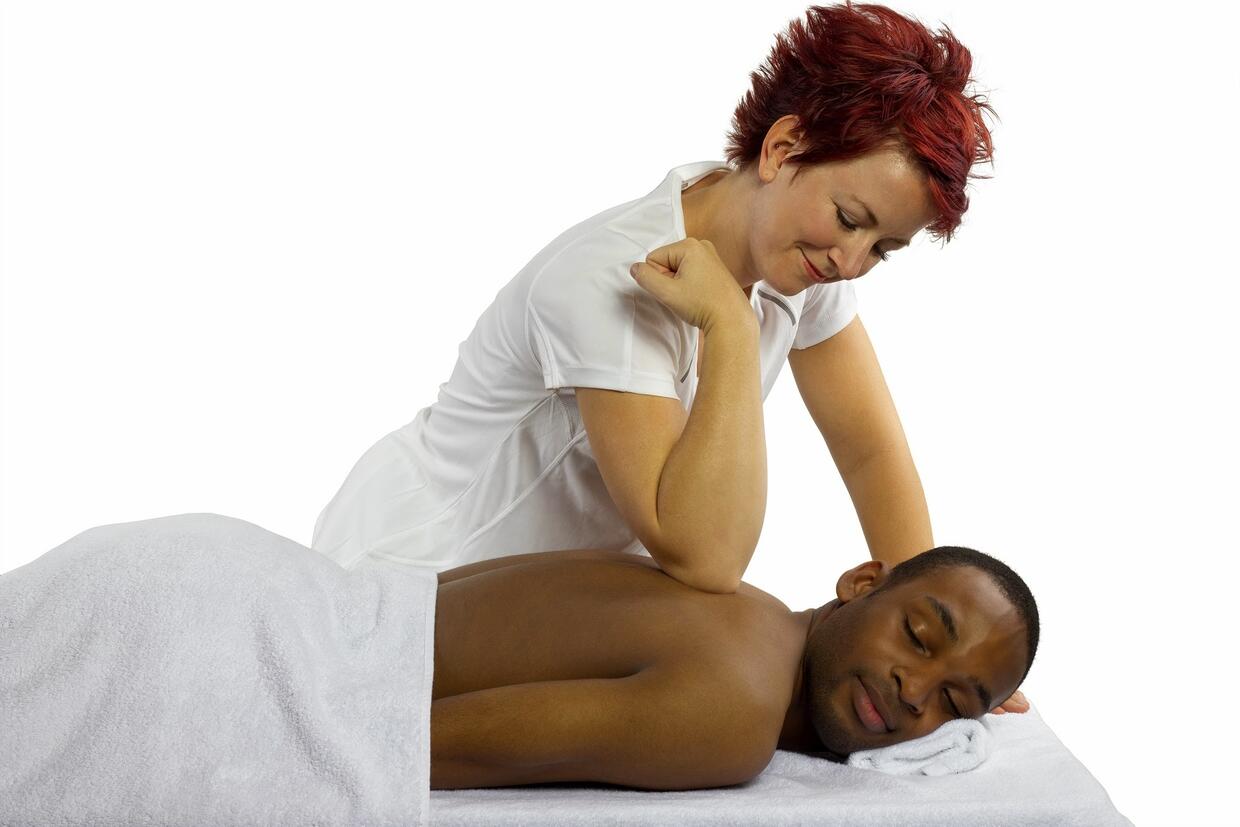 Stock photo 149760965 - young female masseuse treating young male client  with massage